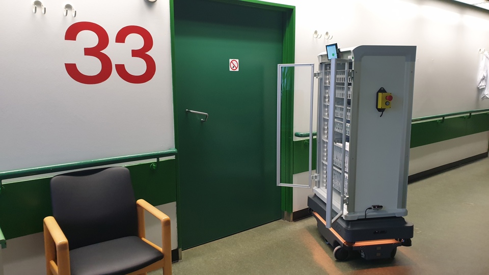 Morecare Service Robot in front of hospital room